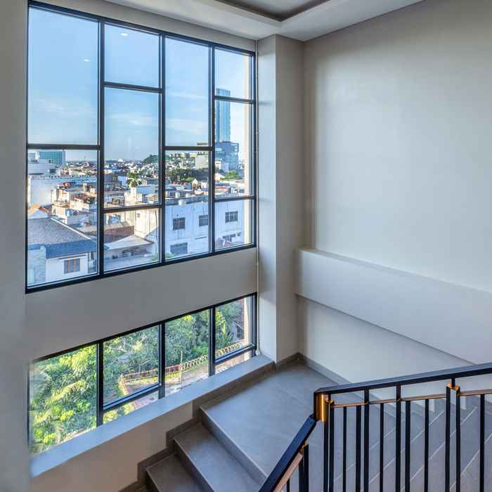 Staircase with city view window